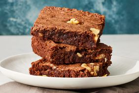 A plate of three stacked brownies