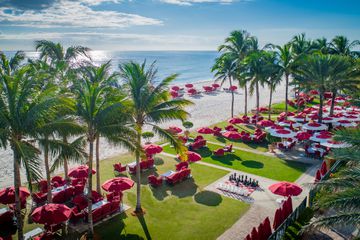 View of front lawn with lounge chairs and beach access