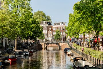 A canal lined with boats on a sunny day