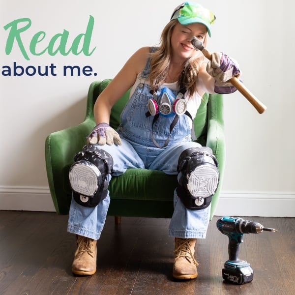 heathered nest owner, heather thibodeau wearing overalls, kneepads, holding hammer seated in green velvet chair. text overlay, read a bit about me